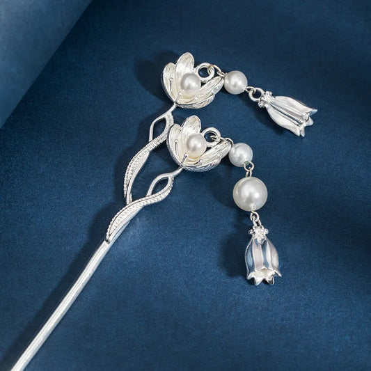 Detailed view of Style A silver lily of the valley hair stick with pearl accents