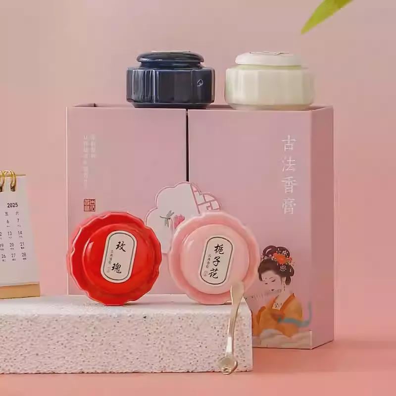 Three small containers on a pink box with decorative elements on a pink background