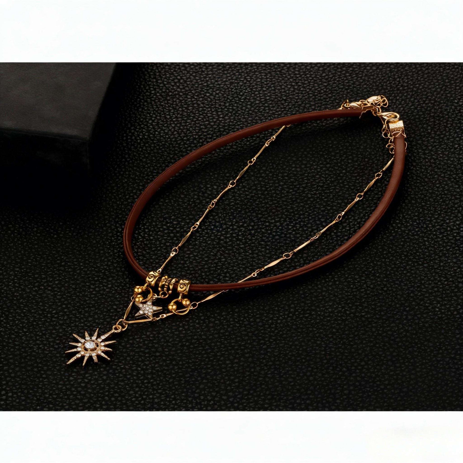 Bracelet with gold chain and star-shaped pendant on a dark background