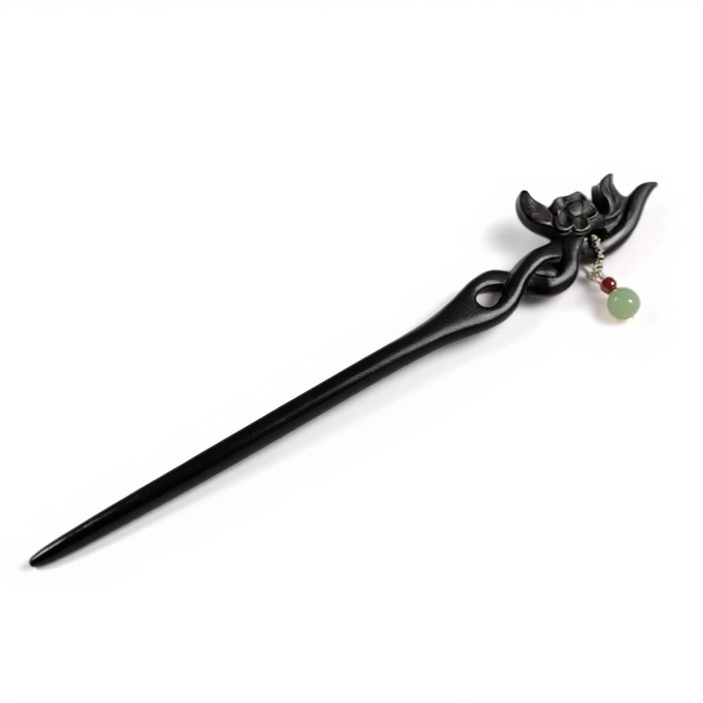 Black hair stick with decorative elements on a white background