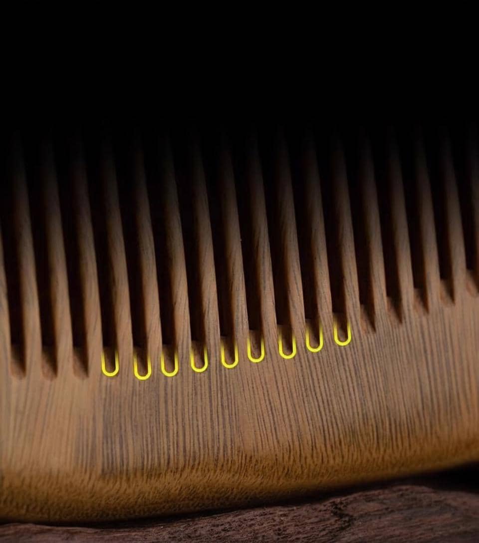 Close-up of a wooden comb with a dark background