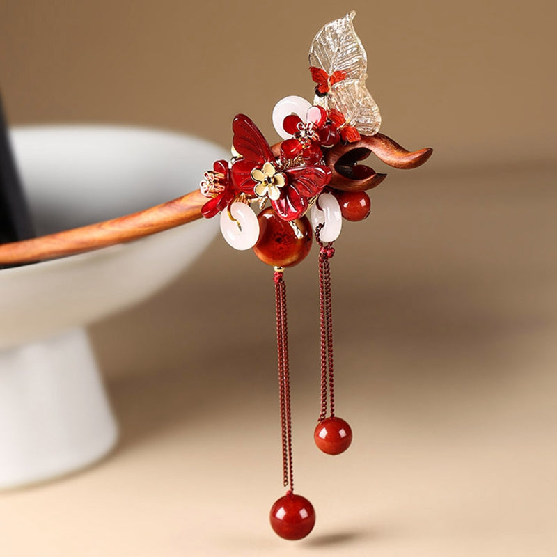 Close up of traditional Chinese cloisonne and jade butterfly on a sandalwood hair pin