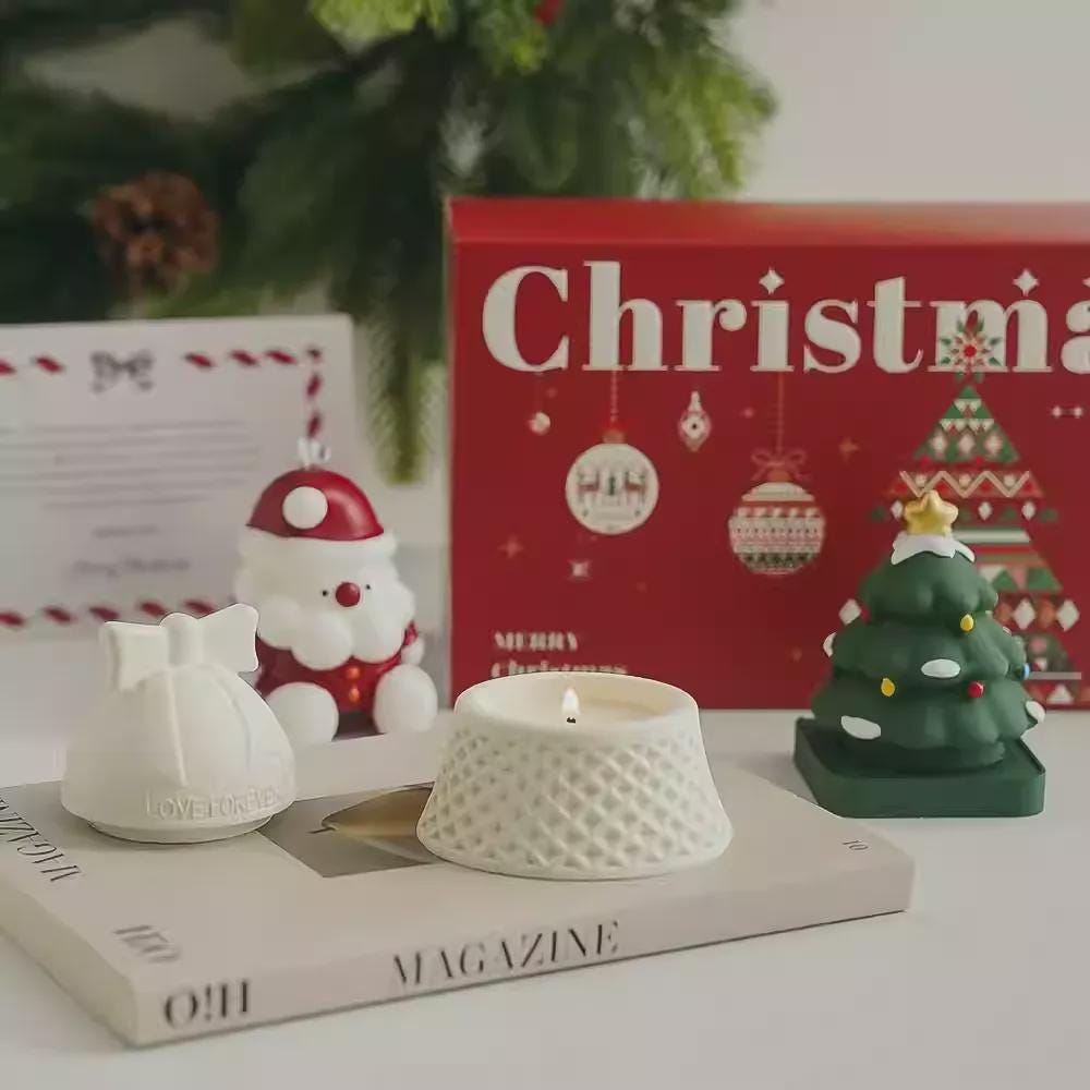 Decorative candles and Christmas-themed items on a magazine with a red 'Christmas' book in the background.