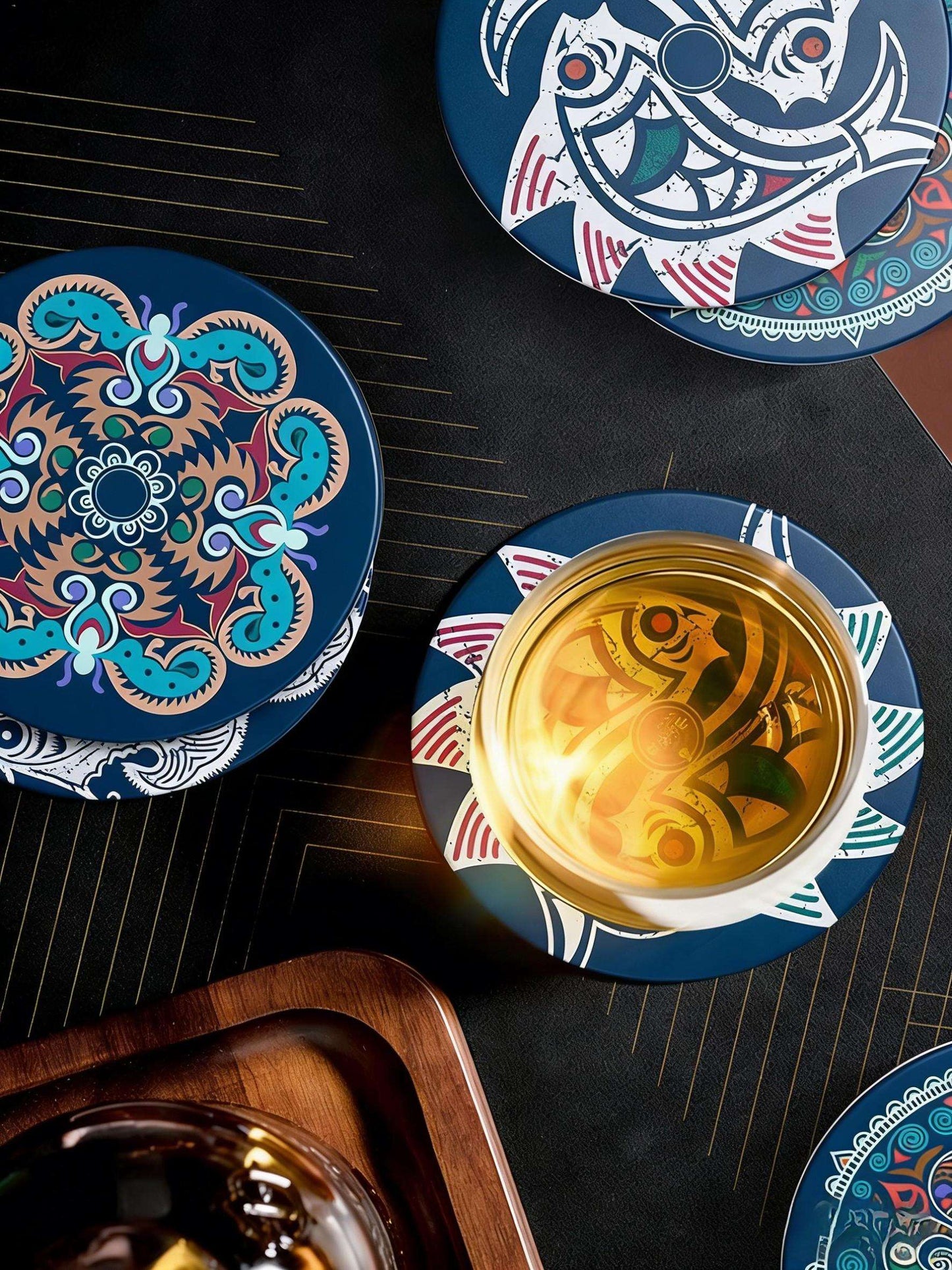 Decorative coasters with intricate designs on a dark surface