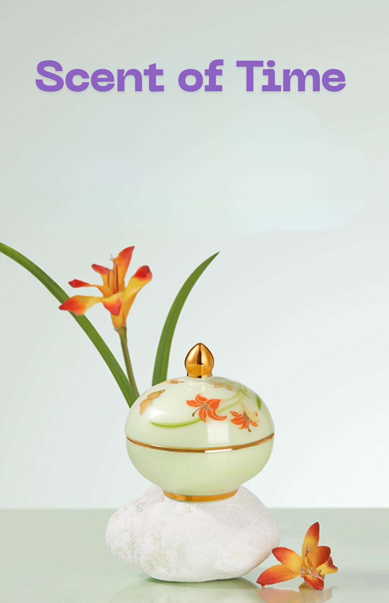 Decorative perfume bottle with floral design on a light background