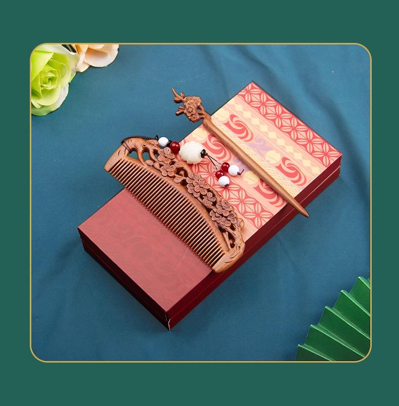Decorative wooden comb and hairpin set with a patterned box on a blue background