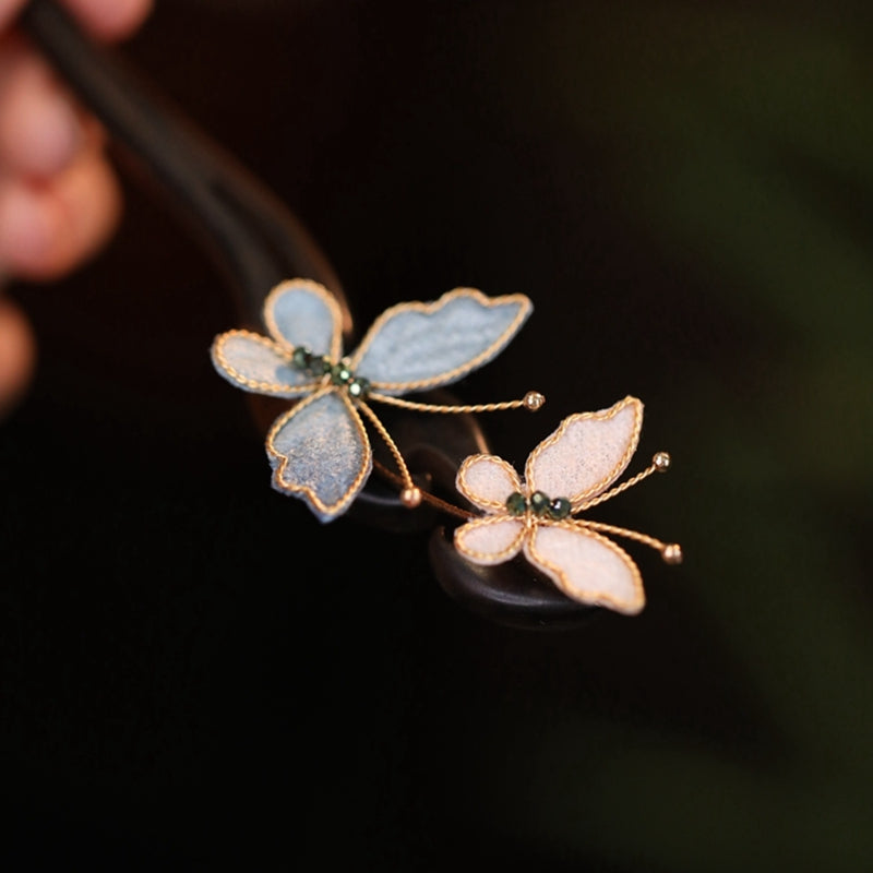 Detailed view of silk mesh butterfly wings and golden copper hair pin accessory