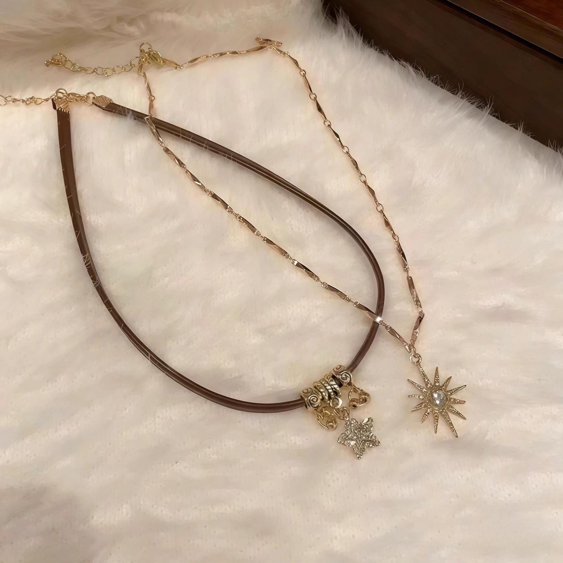 Necklace with star-shaped pendants on a textured surface