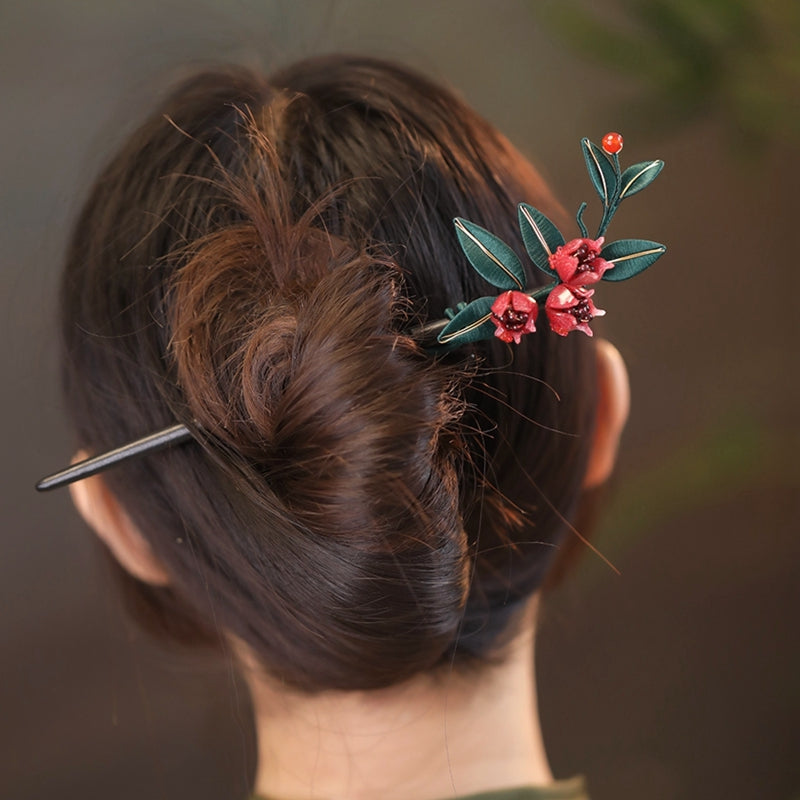 Elegant woman wearing a pomegranate flower wooden hair pin