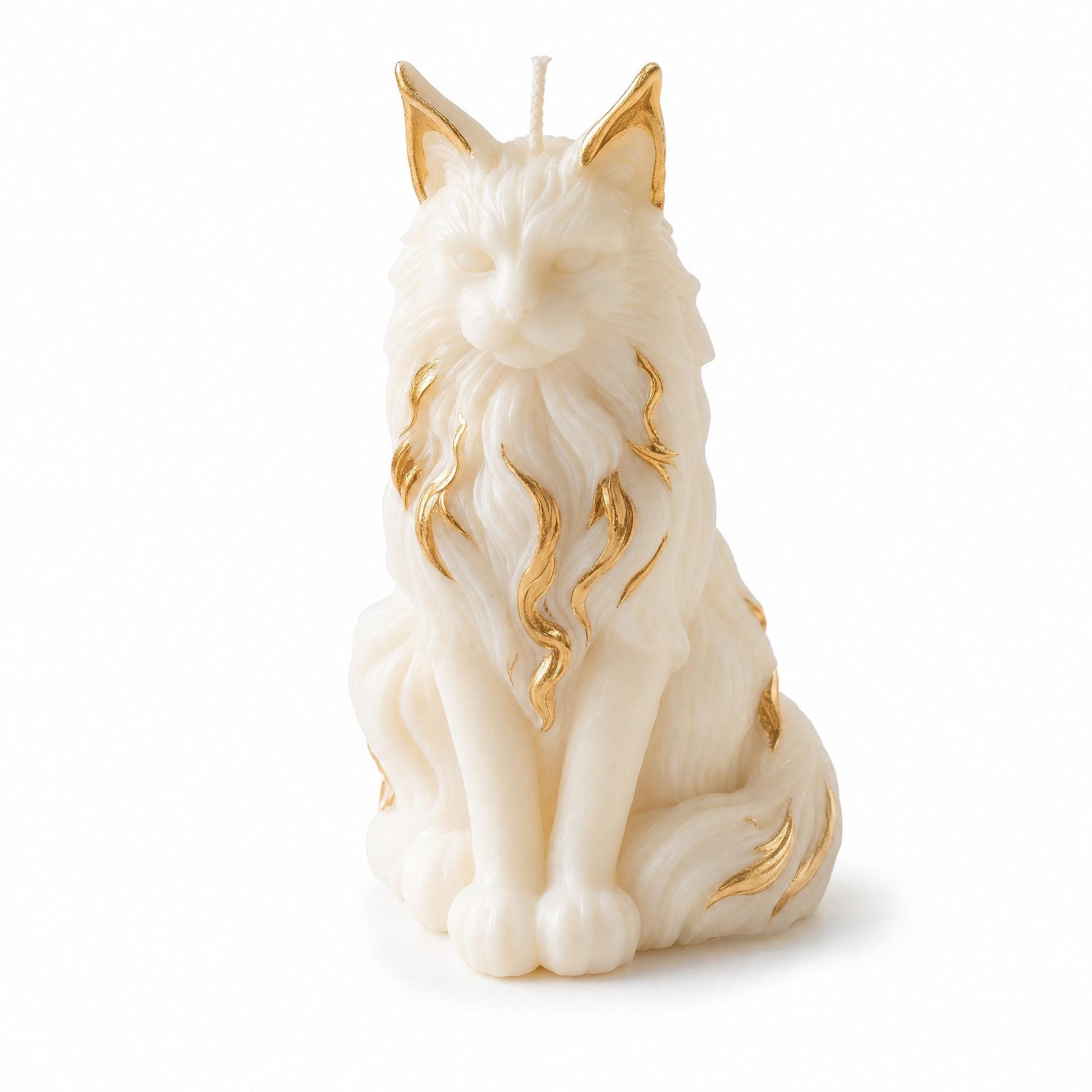 Cat-shaped candle with gold accents on a white background