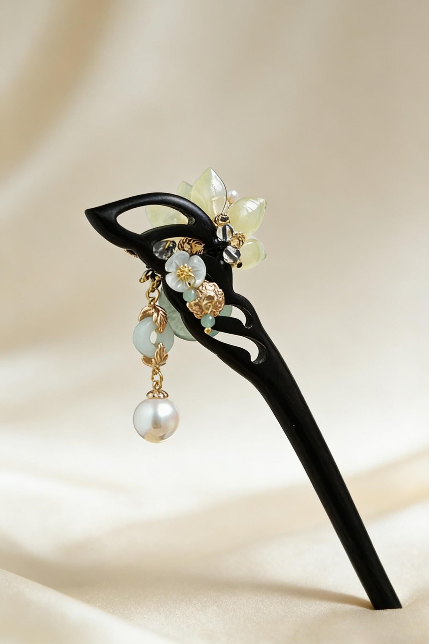 Decorative hairpin with floral design and pearl on a beige background