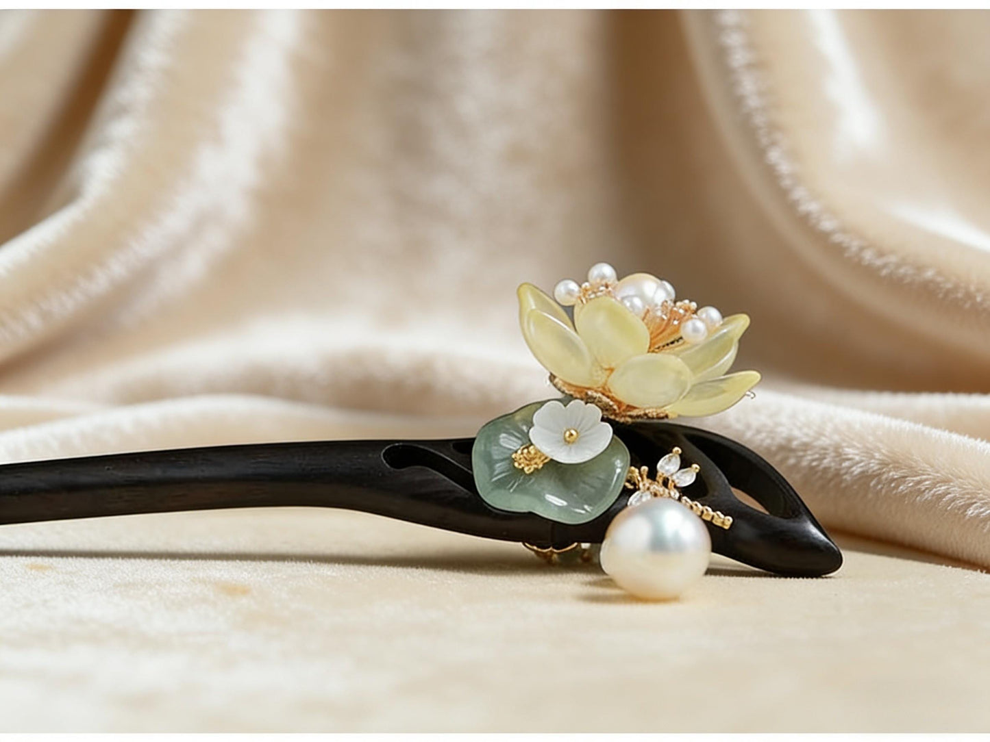 Decorative hairpin with floral and pearl design on a beige fabric background