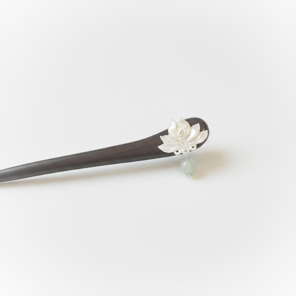Hairpin with a decorative flower on a white background