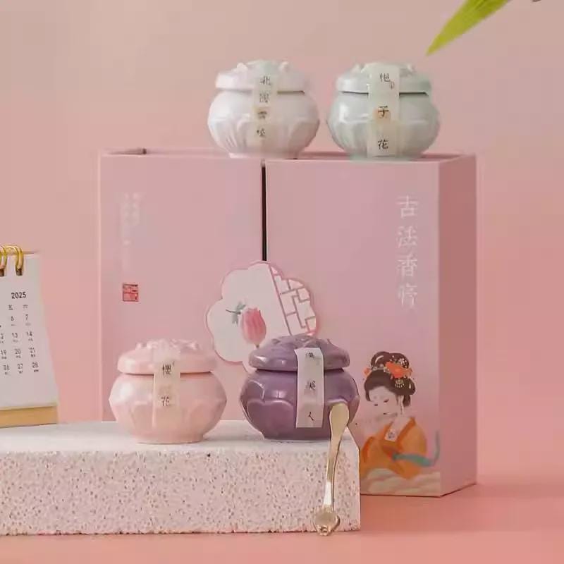 Set of small jars with lids on a pink stand against a pink background