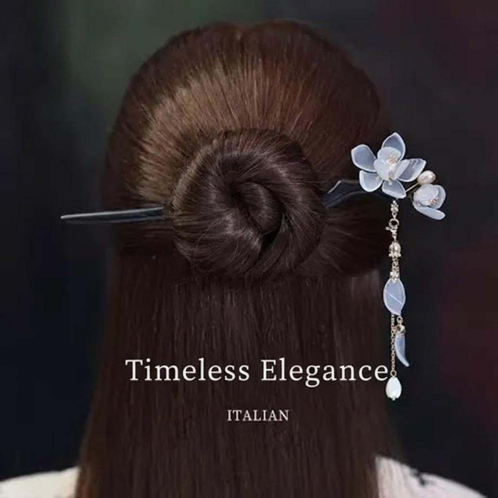 Hairpin with floral design and beads on a bun, labeled 'Timeless Elegance'