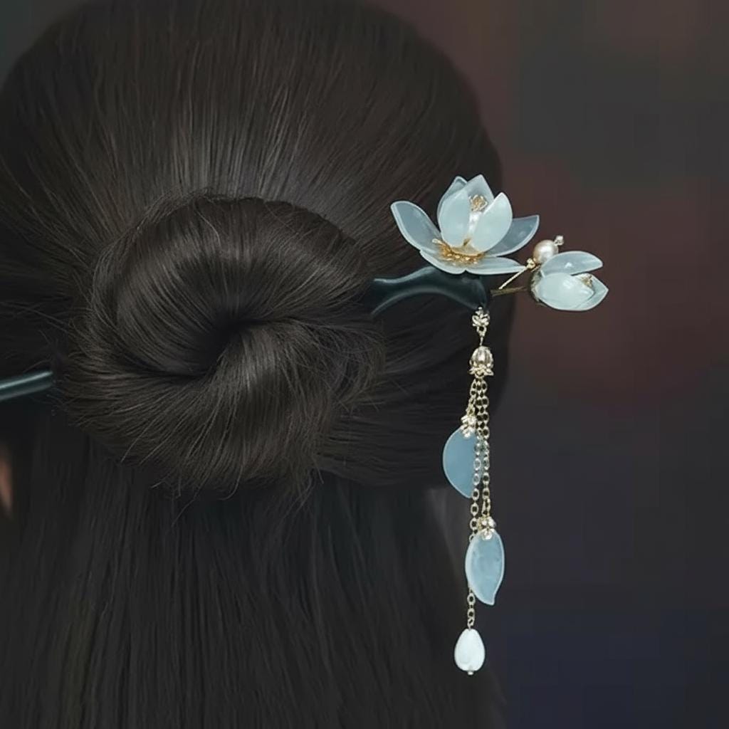 Traditional hairpin with lotus design in a dark hair bun against a dark background