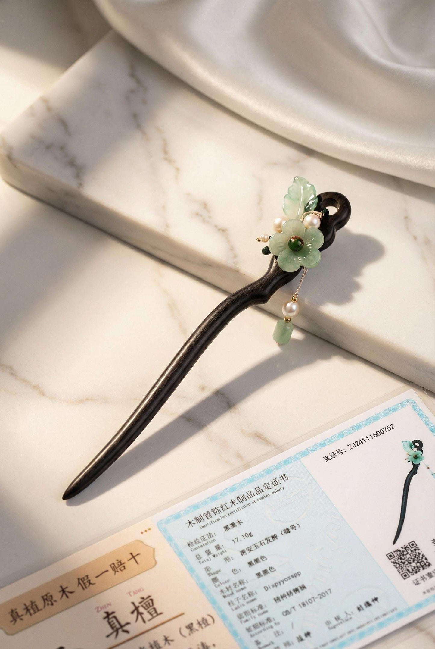 Decorative hairpin with floral design on a marble surface