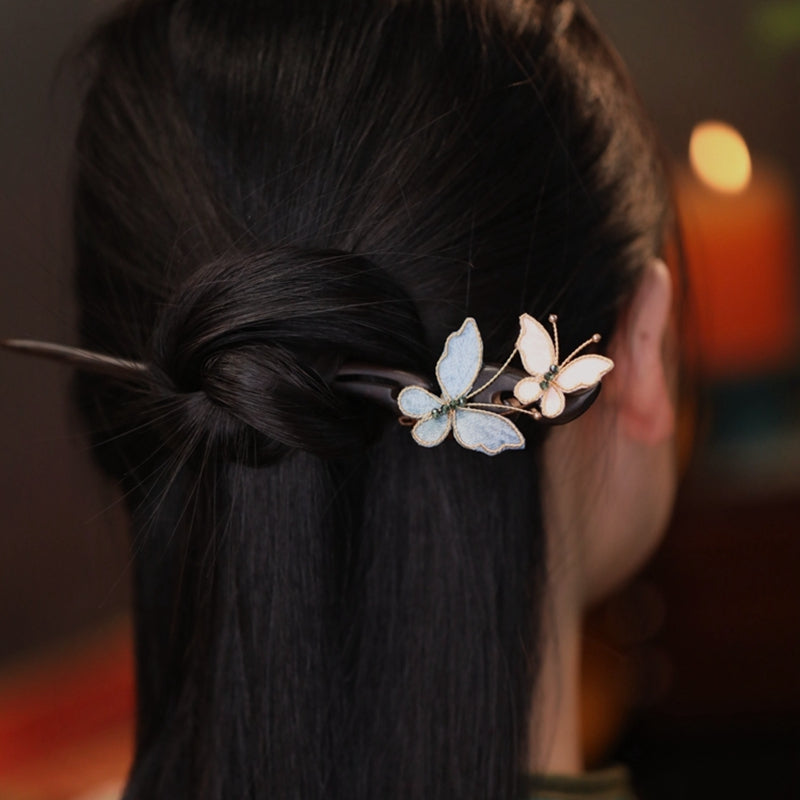 Model wearing butterfly hair pins in a traditional Qipao hairstyle for weddings