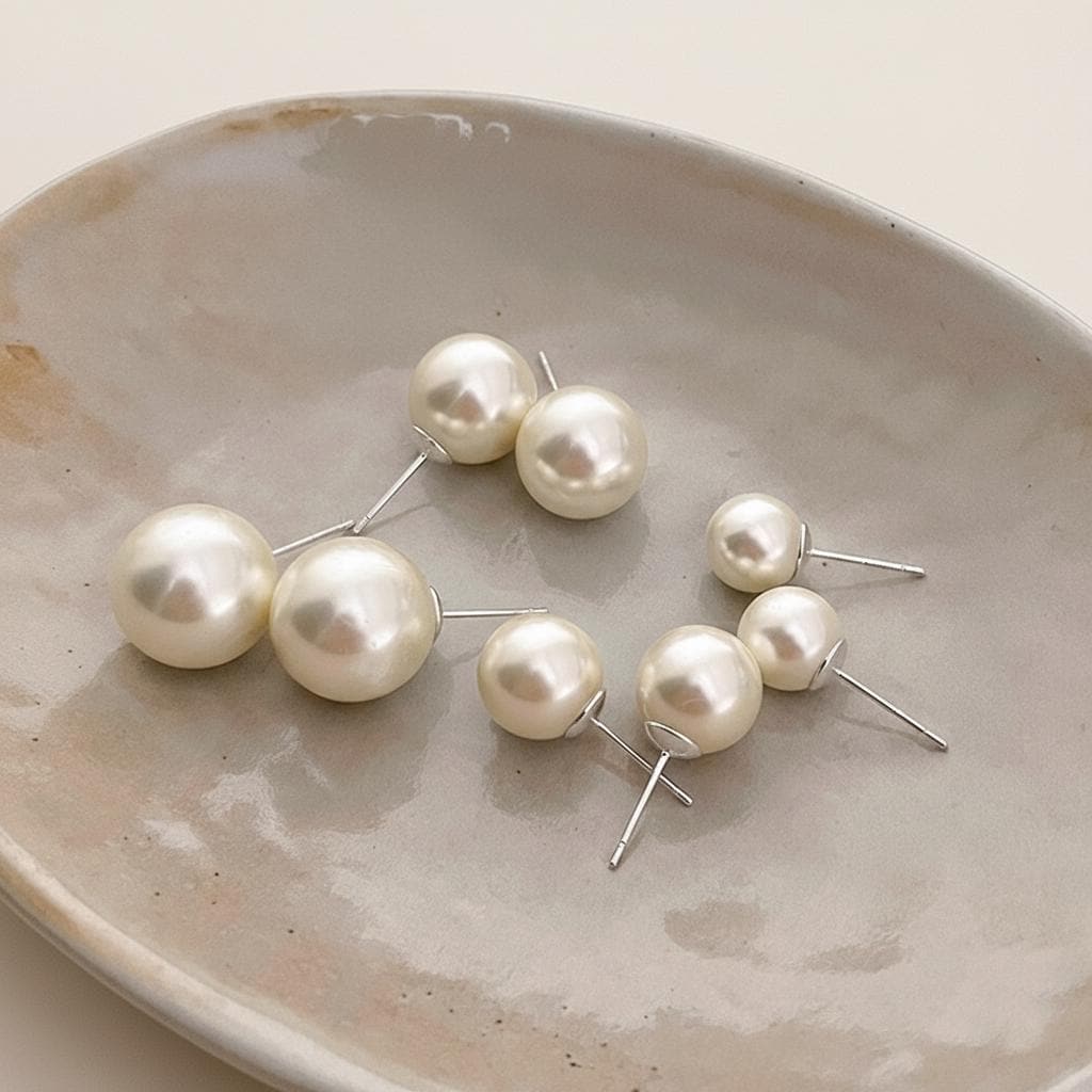Pearl earrings on a textured ceramic plate