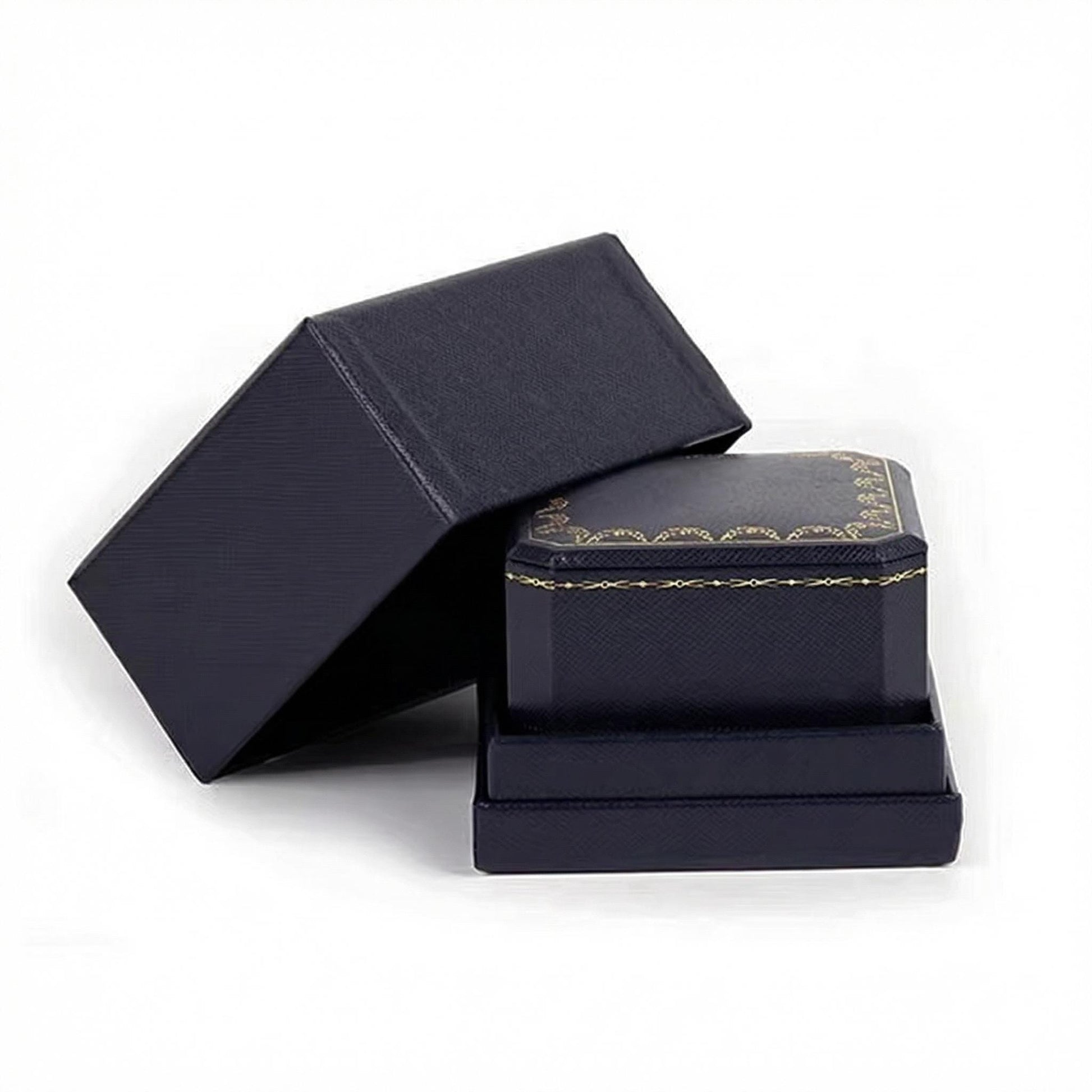 Navy blue jewelry box with gold trim on a white background