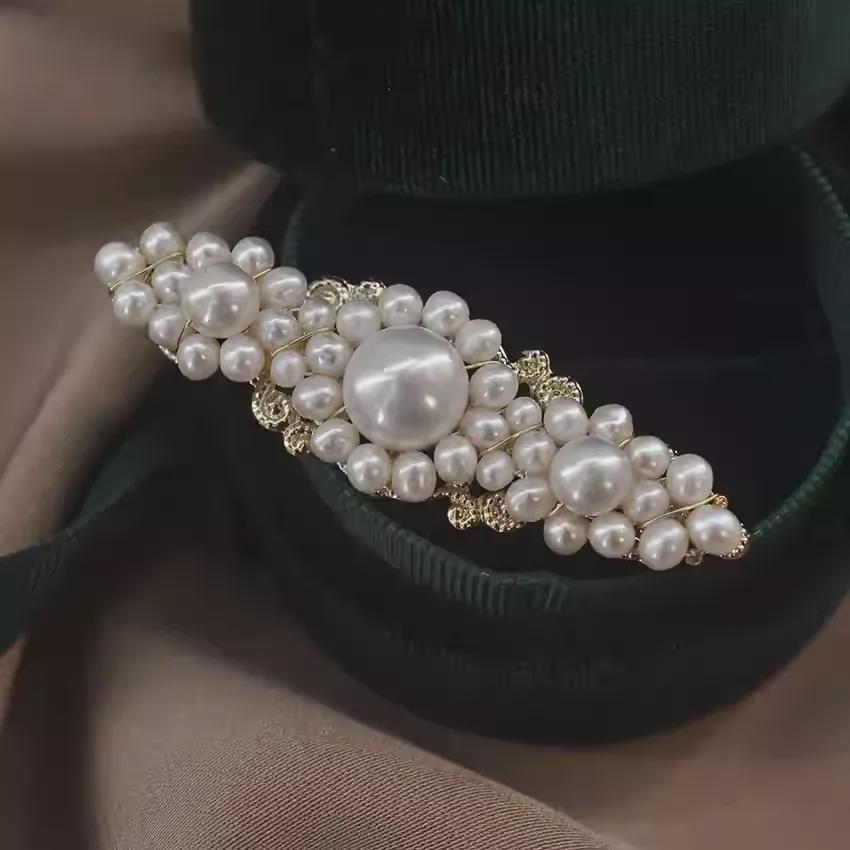 Pearl hair clip on a black velvet surface
