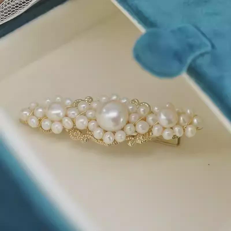 Pearl hair clip on a soft fabric background