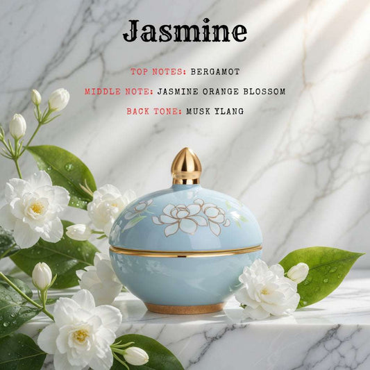 Perfume bottle with jasmine flowers on a marble background