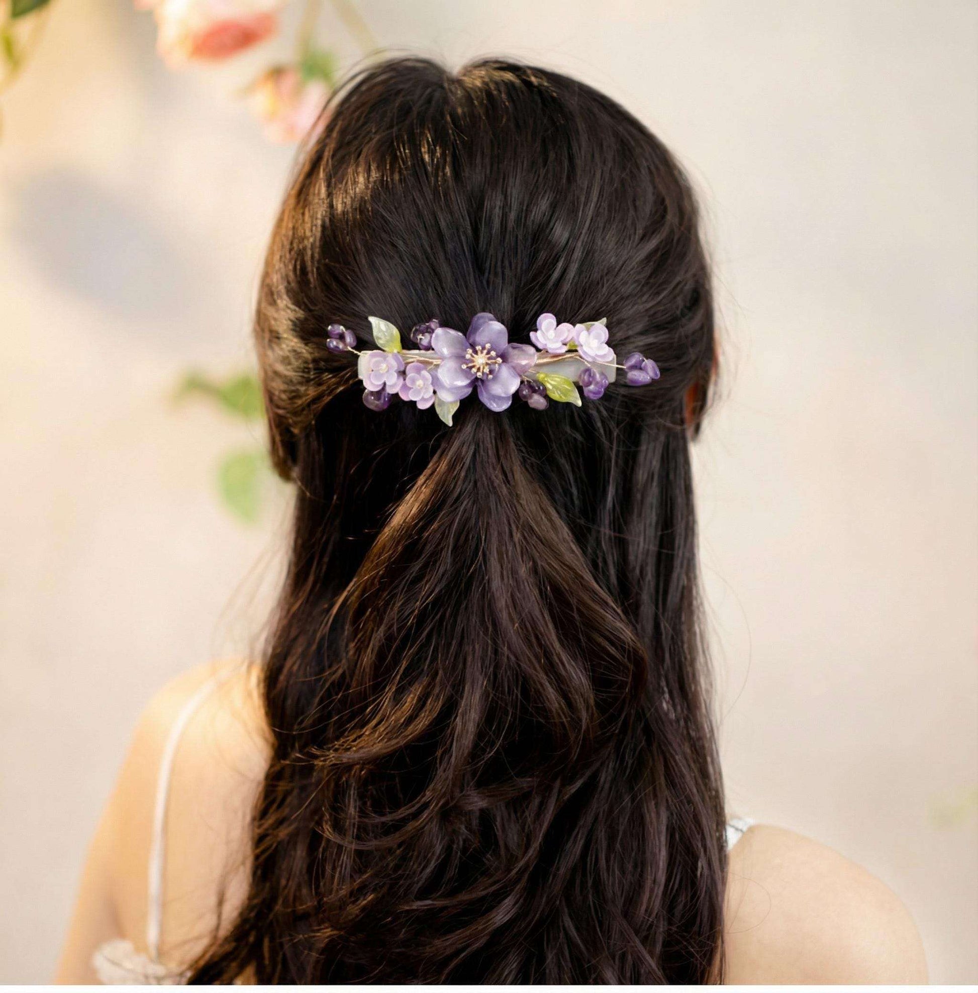 Person with Purple Peony Ronghua Velvet Flower Hair Clip in a blurred indoor setting