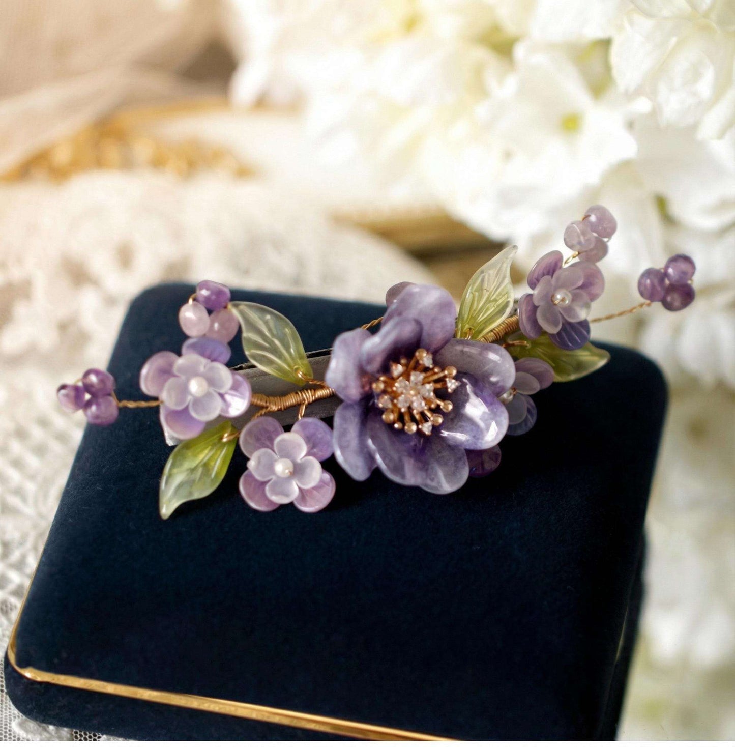 Purple Peony Ronghua Velvet Flower Hair Clip on a dark blue box with a blurred floral background