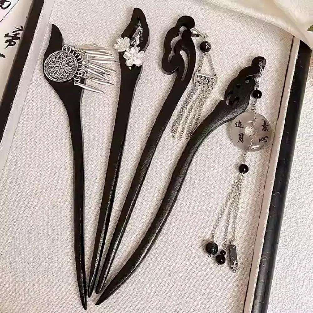 Set of black hair sticks with decorative elements on a white background