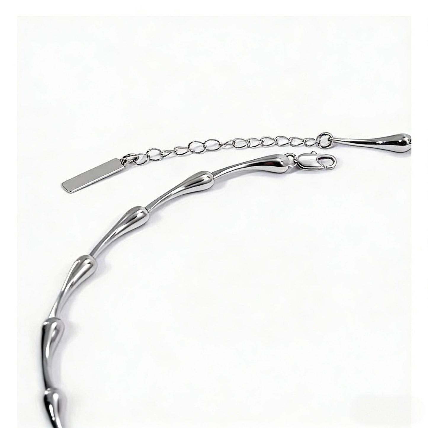 Silver water drop bracelet on a white background