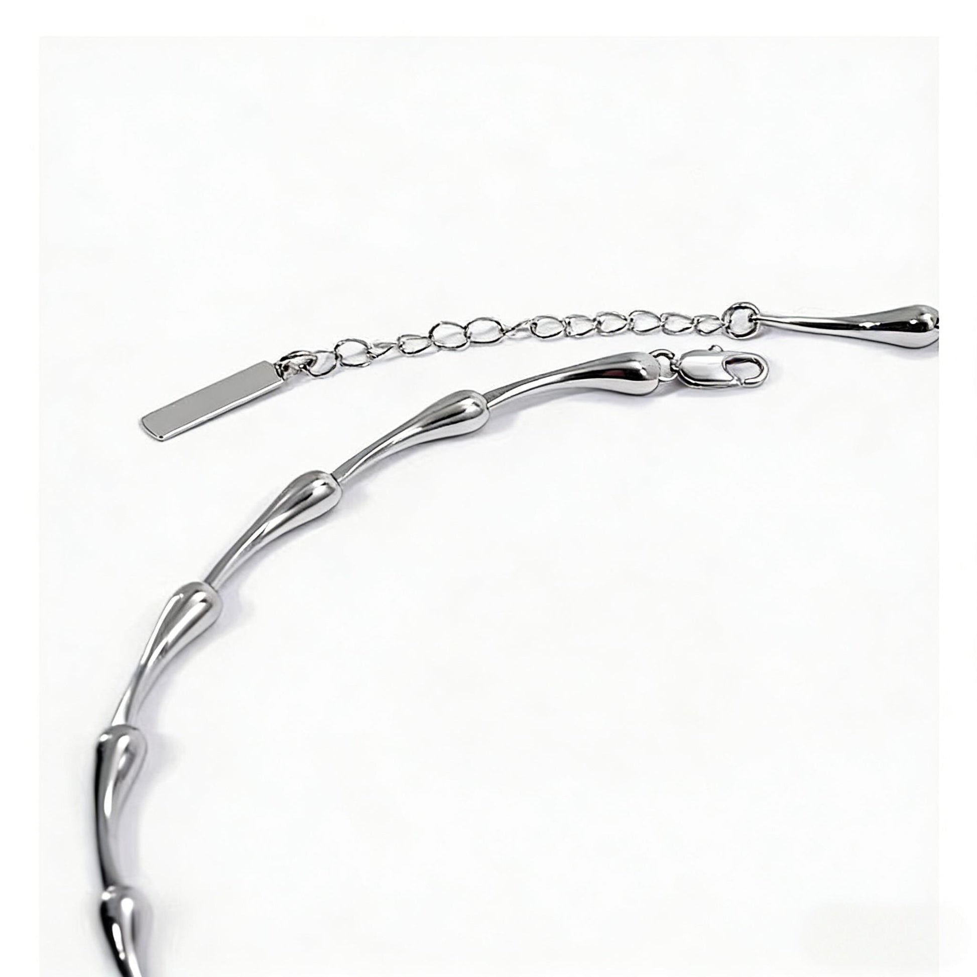 Silver water drop bracelet on a white background