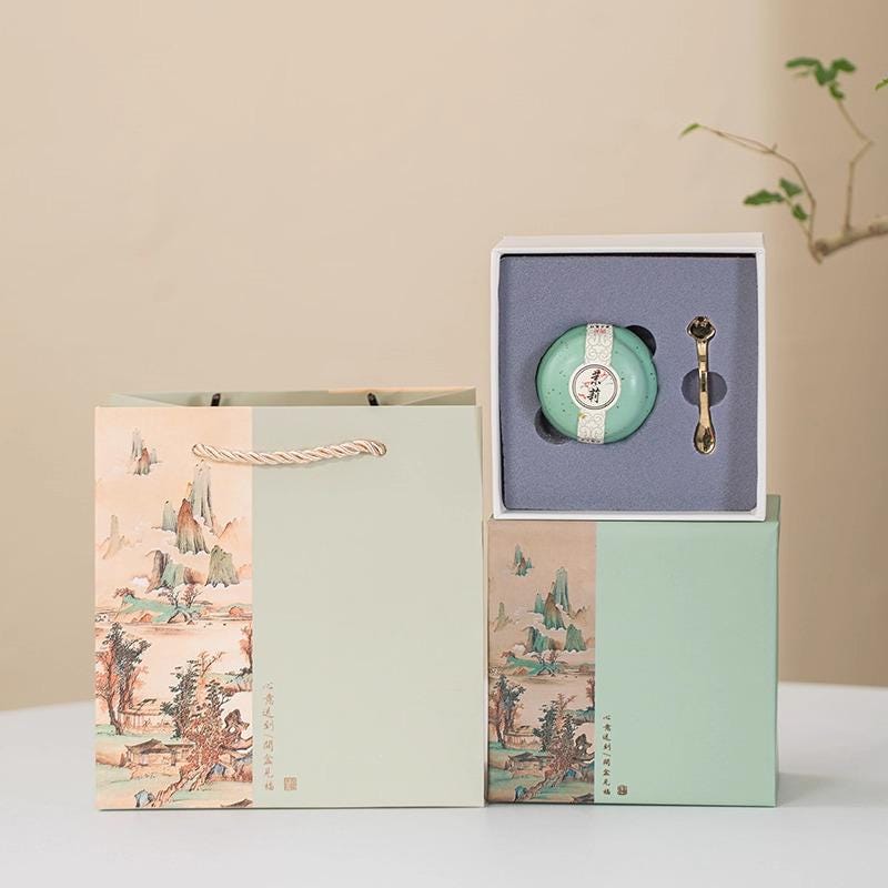 Solid Perfume, Balm and silver spoon in a decorative box on a beige background