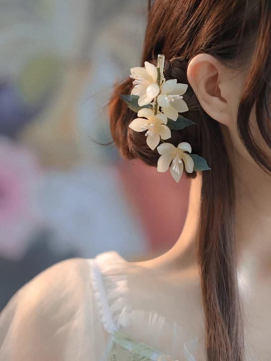 Woman with floral hair accessory and blurred background