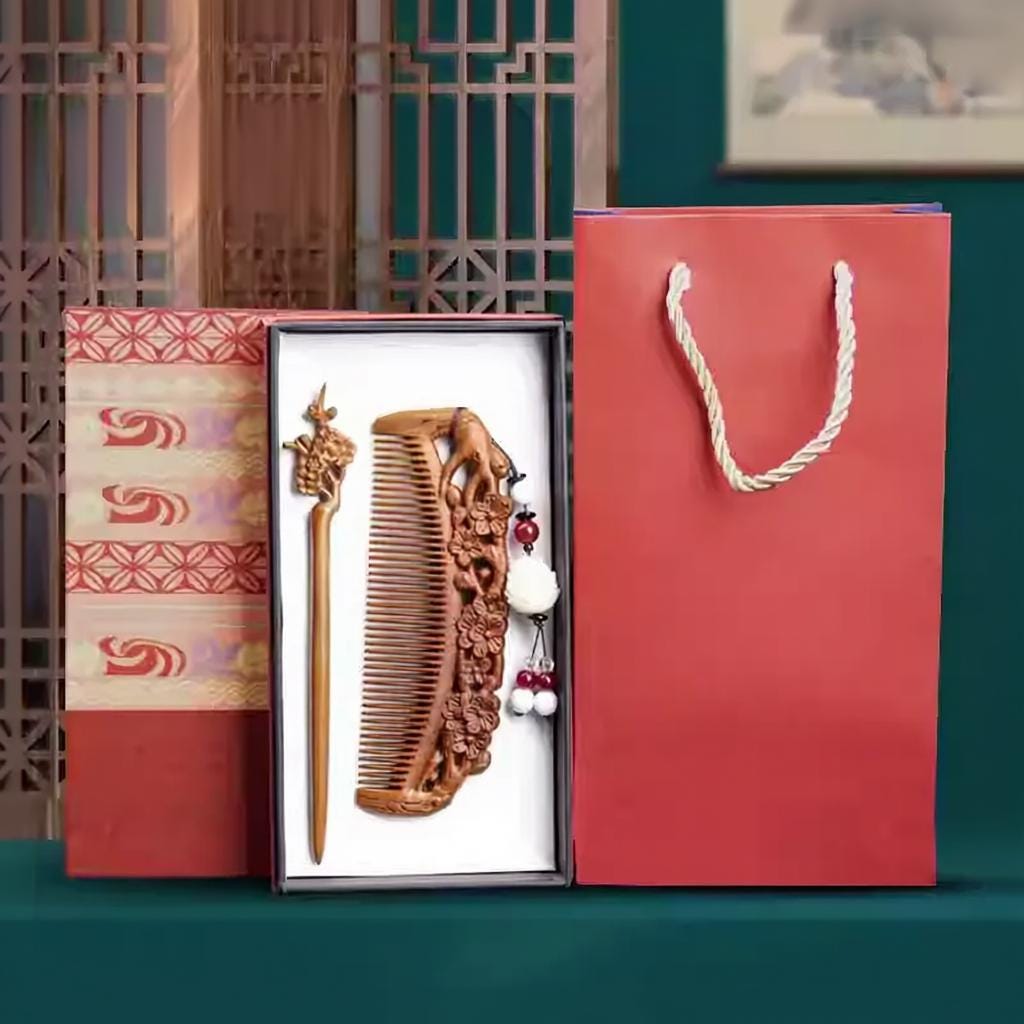 Wooden comb and a hair pin in a gift box with a red bag on a green background
