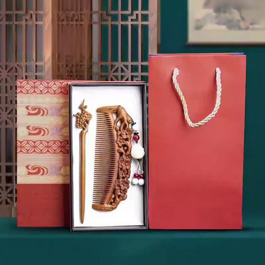 Wooden comb and a hair pin in a gift box with a red bag on a green background