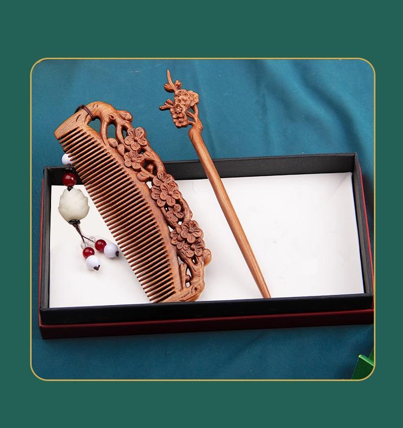 Wooden comb and hairpin set in a black box on a teal background