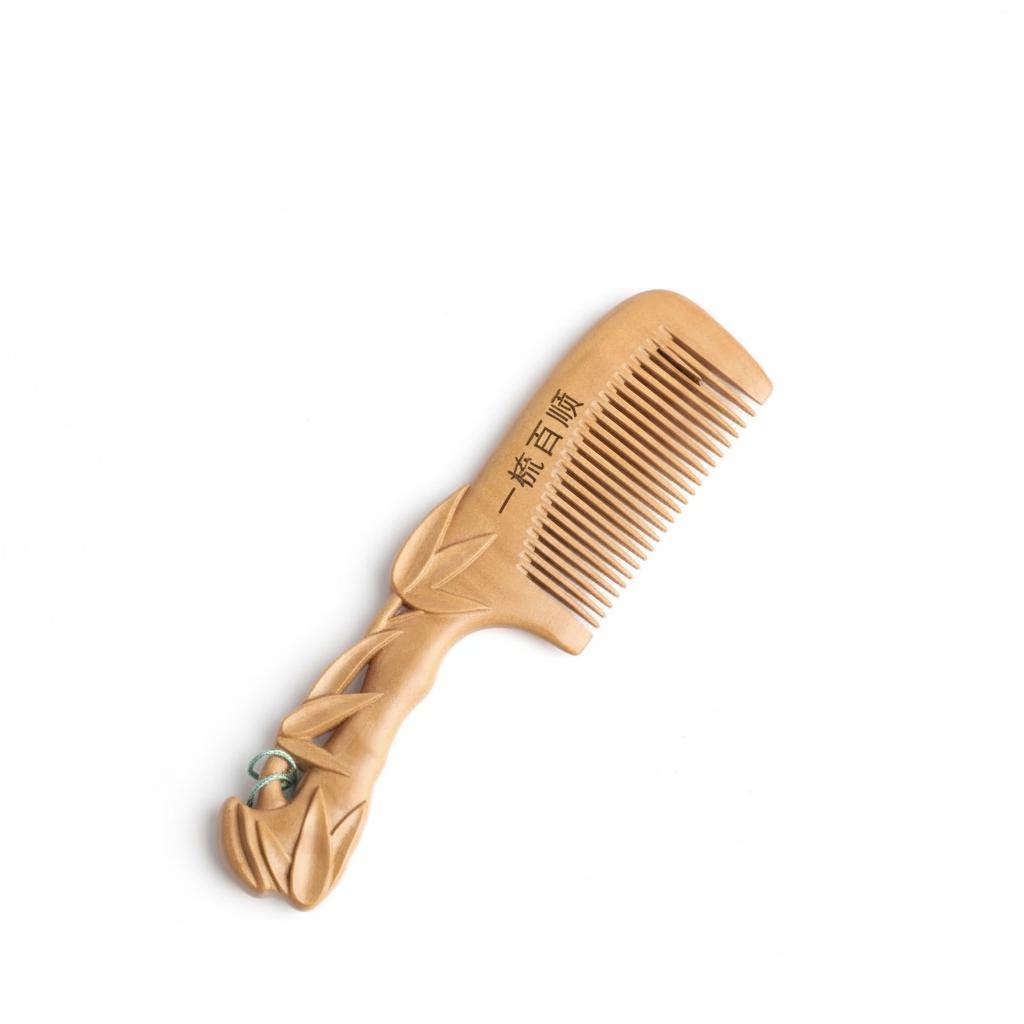 Wooden comb with decorative handle on a white background