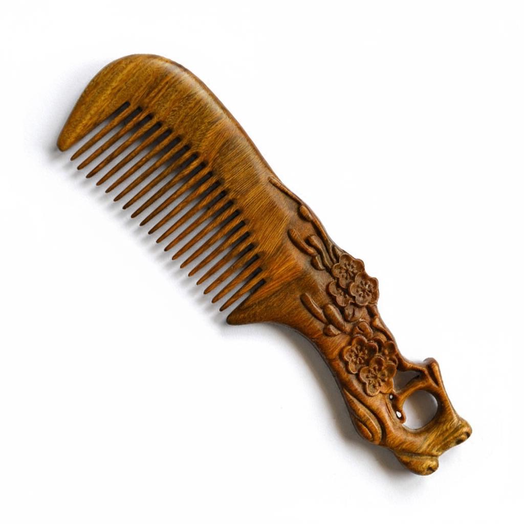 Wooden comb with floral carvings on a white background