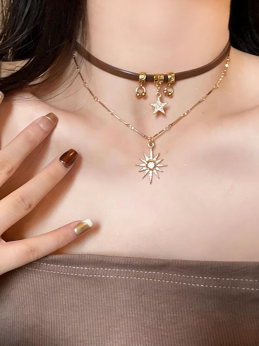Necklace with star and sun pendant worn by a person