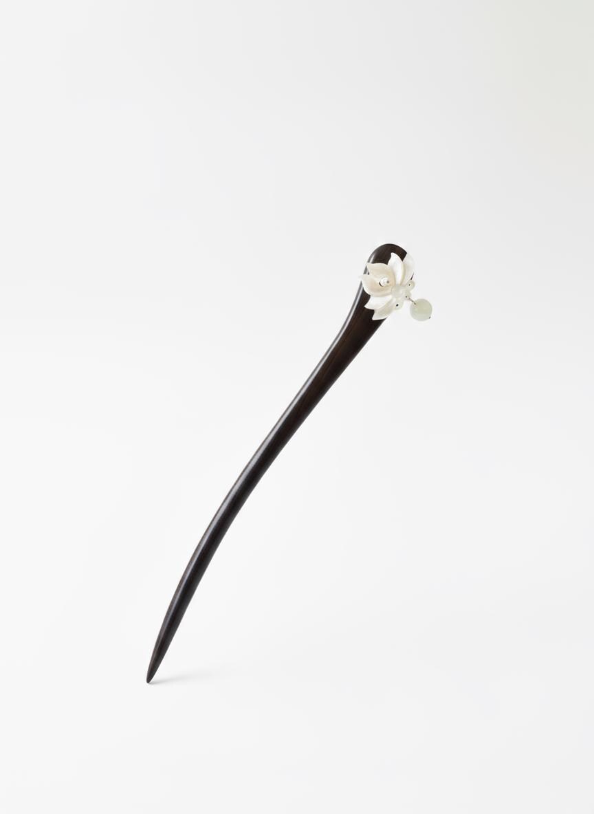 Black hairpin with white floral design on a white background