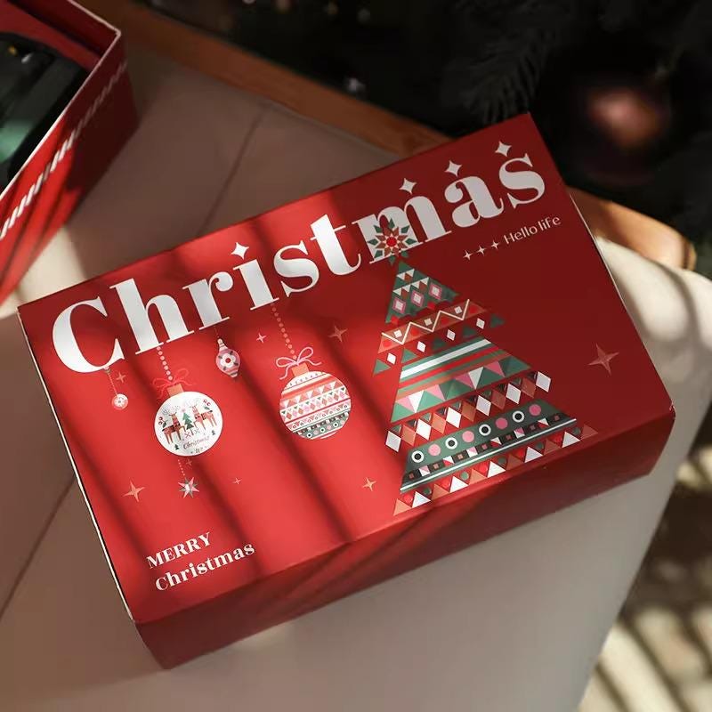 Red Christmas-themed box with festive designs on a neutral background