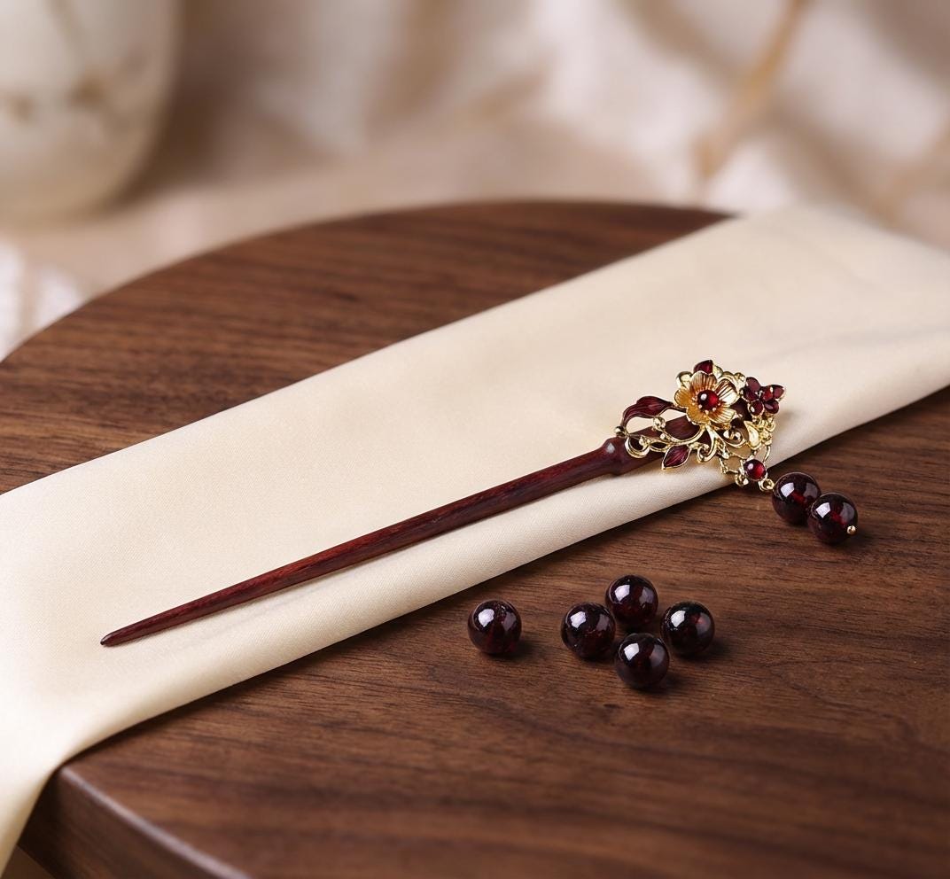 Decorative hair stick with gemstones on a wooden surface