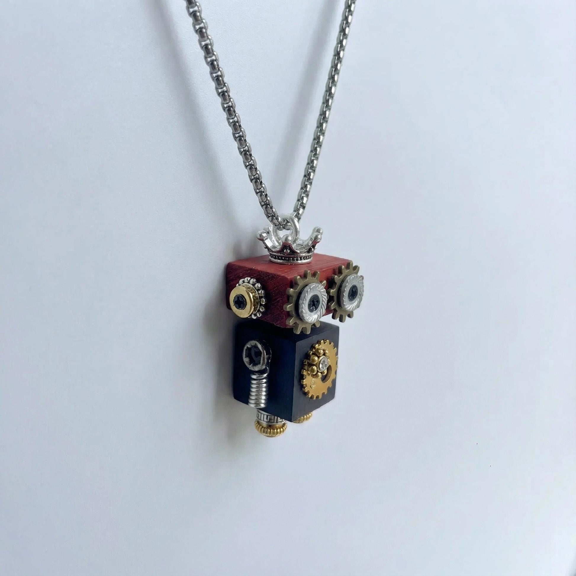 Steampunk-style necklace with a cube-shaped pendant on a light gray background